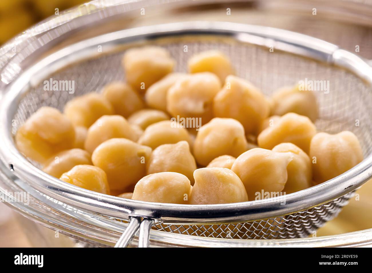 chickpeas being sieved to extract aquafaba, cooking liquid used as an ...