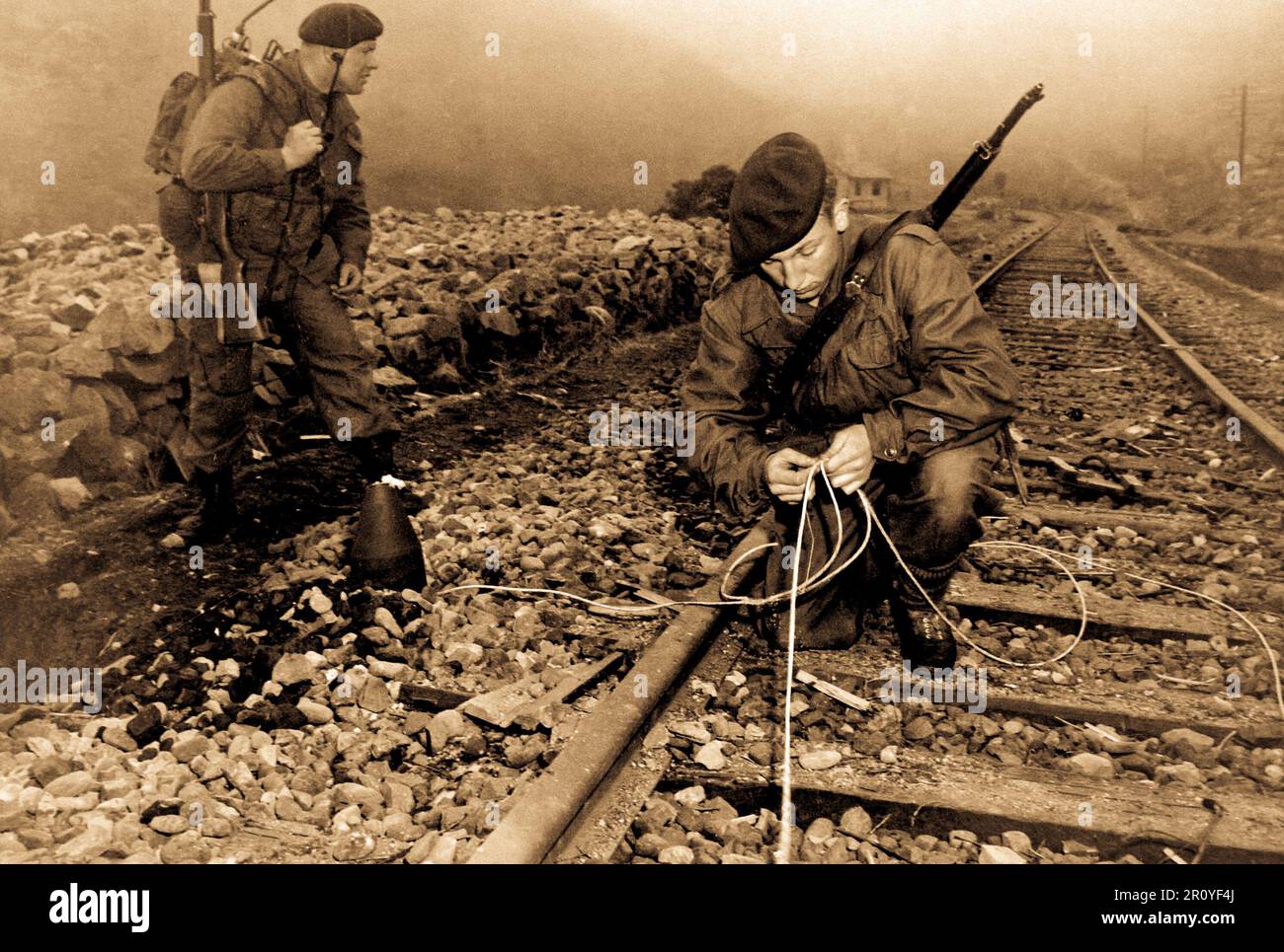 Commandoes of the 41st Royal British Marines plant demolition charges along railroad tracks of enemy supply line which they demolished during a commando raid, 8 miles south of Songjin, Korea.  April 10, 1951. Stock Photo