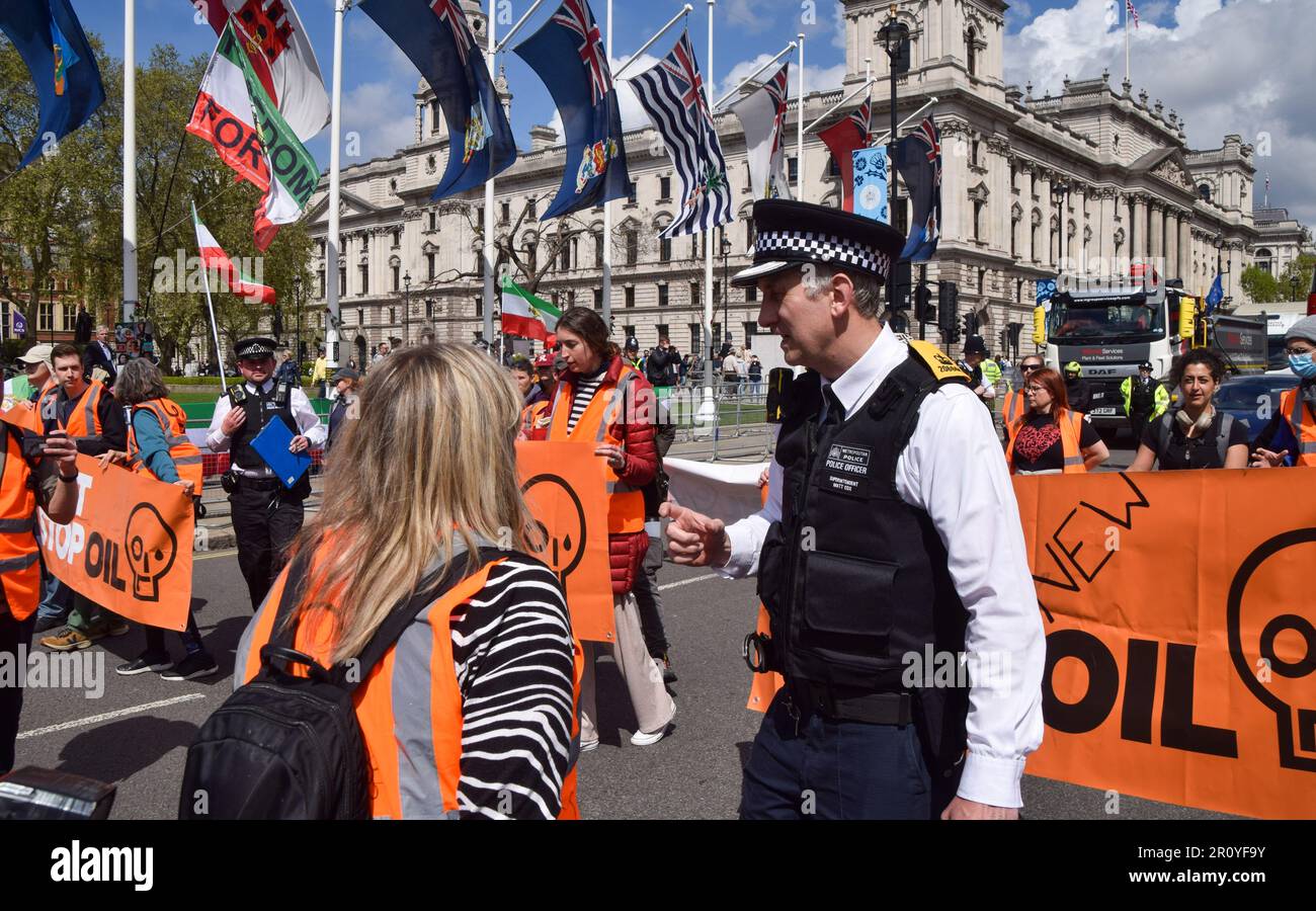 London, UK. 10th May, 2023. A police officer warns protesters to get off the road or face arrest during the demonstration. Just Stop Oil activists blocked the traffic in Parliament Square with a slow march as the climate group continue their protests, demanding that the government stops issuing new oil and gas licences. Credit: SOPA Images Limited/Alamy Live News Stock Photo