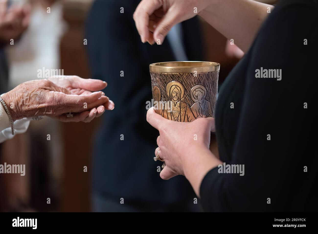 Receiving hands in position to take the Eucharistic Communion bread in