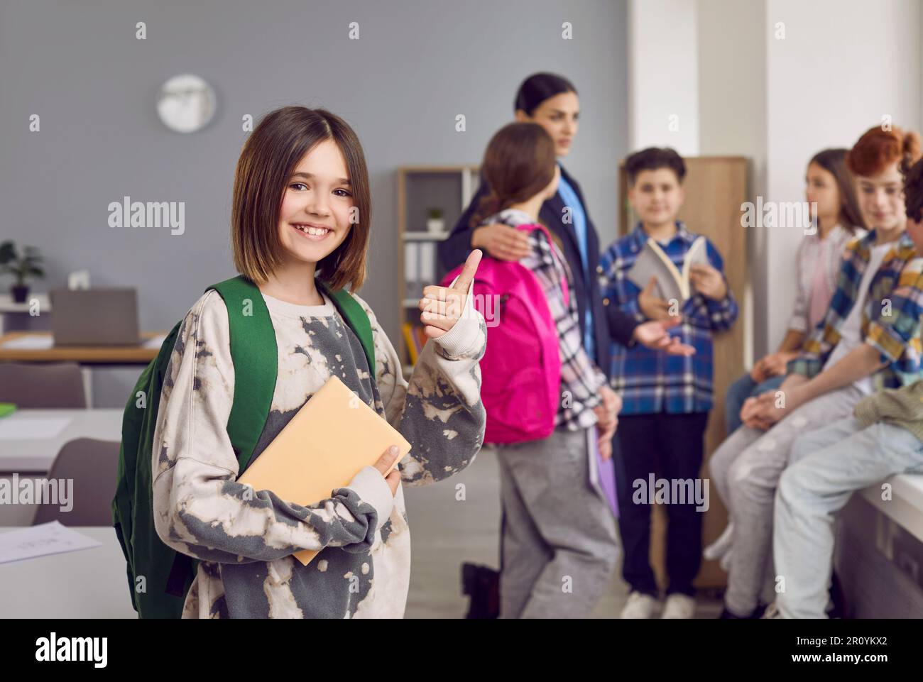 Portrait of happy girl school student showing thumb up Stock Photo - Alamy