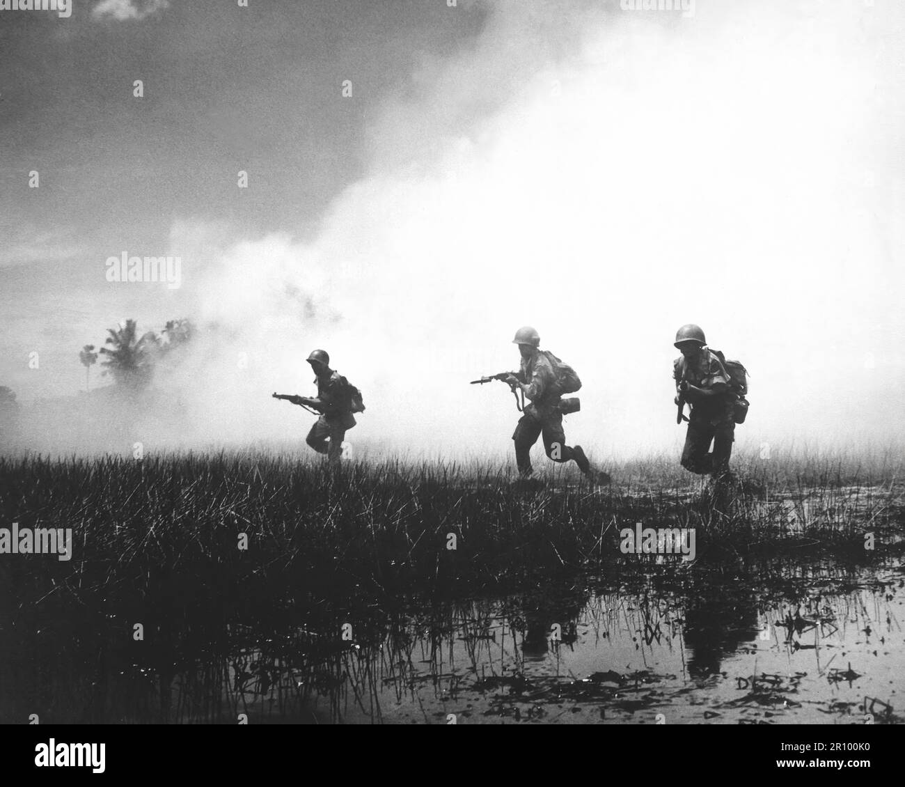 Troops of the Vietnamese Army in combat operations against the Communist Viet Cong guerillas.  Marshy terrain of the delta country makes their job of rooting out terrorists hazardous and extremely difficult. Circa 1961. Stock Photo