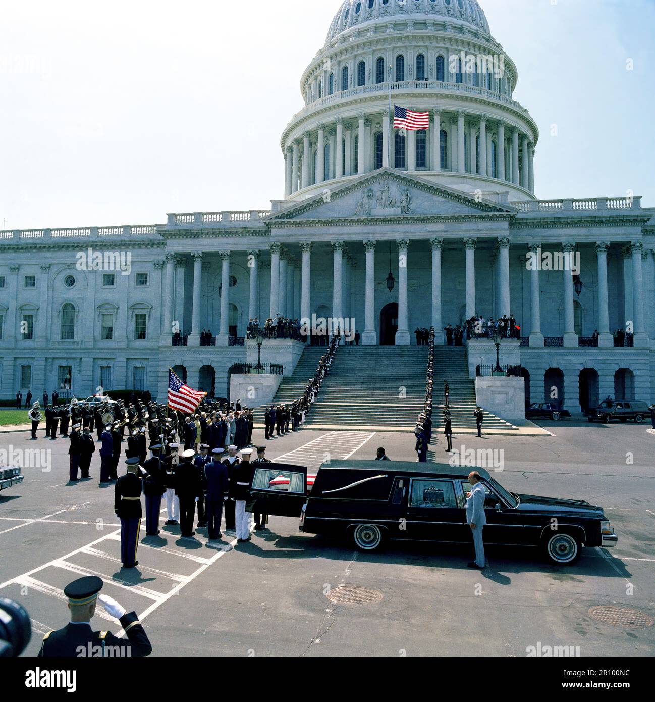 A joint services casket team removes the casket of the Unknown Serviceman of the Vietnam Era from a hearse parked outside the east entrance of the Capitol.  The casket will be carried past the color guard and joint services honor condon lining the steps of the Capitol and placed in the rotunda, where the Unknown will lie in state until Memorial Day. Stock Photo