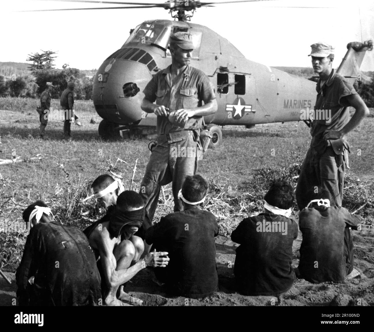 Operation Starlight, a U.S. Marine Corps search and destroy operation south of Chu Lai.  VC casualties stood at 599 killed and six captured.  Viet Cong prisoners await being carried by helicopter to rear area.  August 1965. Stock Photo
