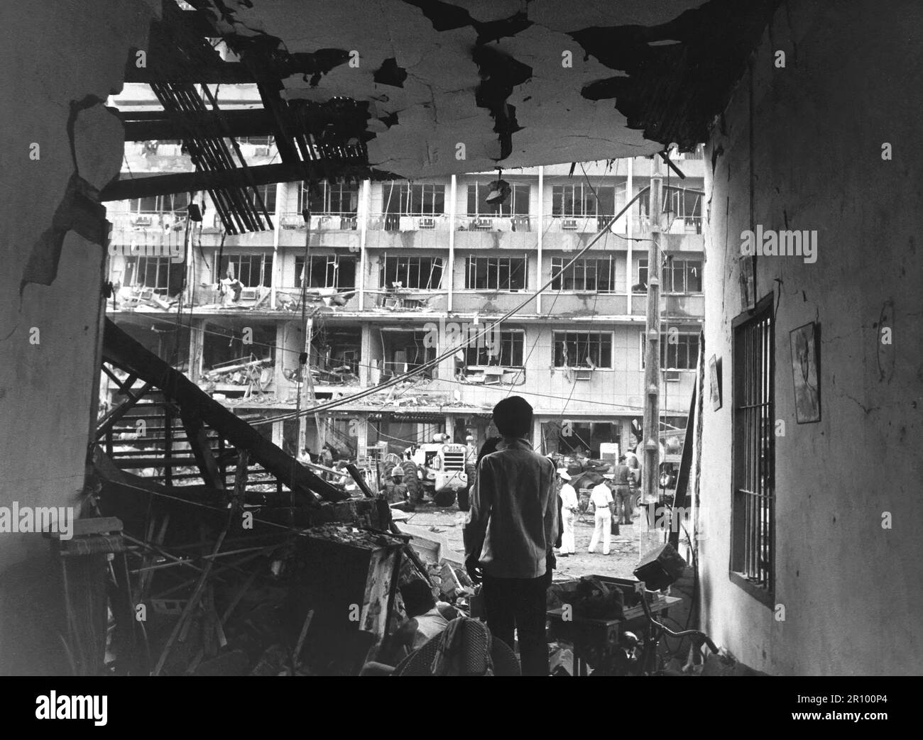 Four Vietnamese and three Americans were killed, and dozens of Vietnamese buildings were heavily damaged during a Viet Cong bomb attack against a multi-story U.S. officers billet in Saigon.  April 1, 1966. Stock Photo