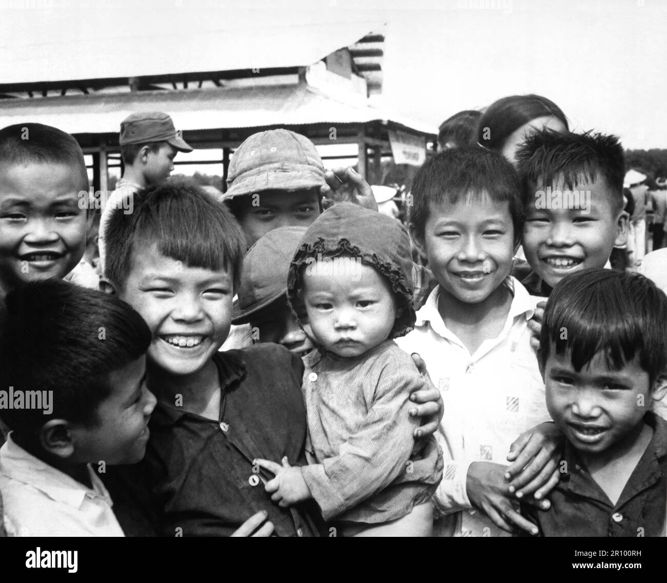 A new market for "Tinh Thuong."  Children gather before the market which was built with assistance from the government of Vietnam and USAID. Stock Photo