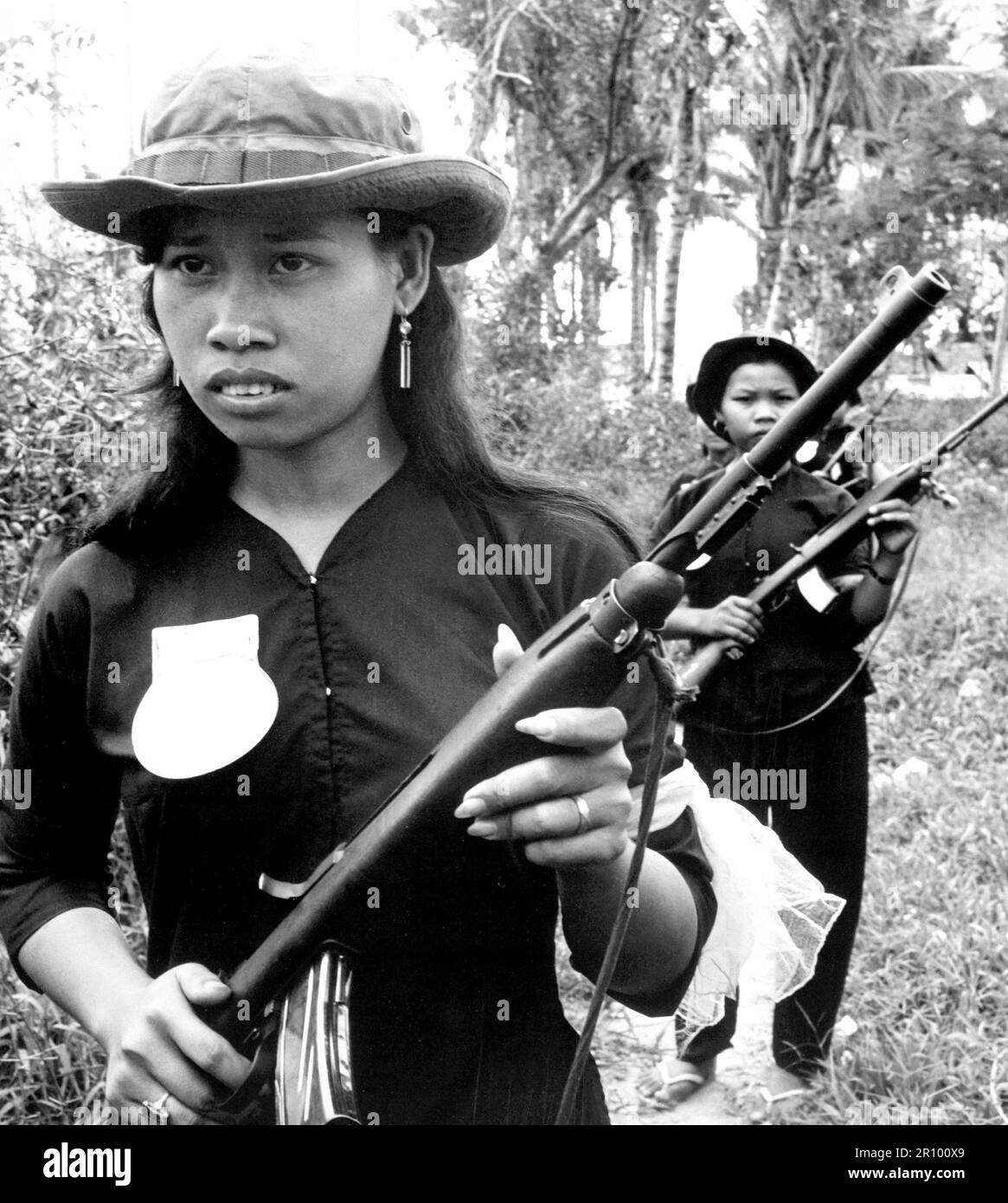 Teenage female volunteers of the People's Self-Defense Force of Kien Dien, a hamlet of Ben Cat district 50 kilometeres north of Saigon, patrol the hamlet's perimeter on January 1,1960 to discourage Viet Cong infiltration. Stock Photo