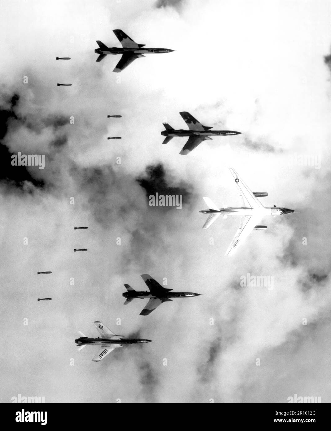 Flying under radar control with a B-66 Destroyer, Air Force F-105 Thunderchief pilots bomb a military target through low clouds over the southern panhandle of North Viet Nam.  June 14, 1966. Photograph by Lt. Col. Cecil J. Poss, USAF. Stock Photo