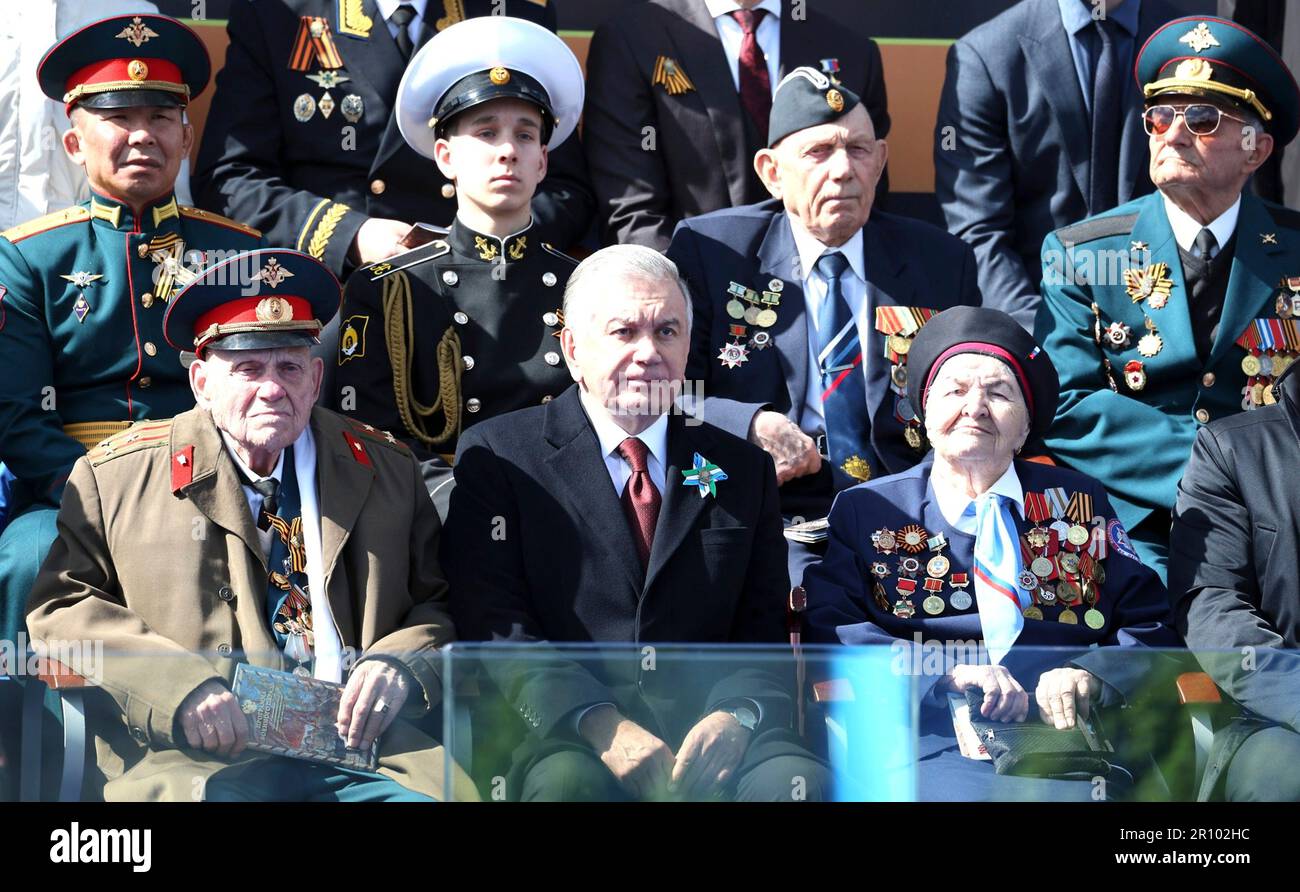 Moscow, Russia. 09th May, 2023. Uzbek President Shavkat Mirziyoyev, center, alongside veterans watches the annual Victory Day military parade through Red Square, marking the 78th anniversary of the victory over Nazi Germany in World War Two, May 9, 2023 in Moscow, Russia. Credit: Gavriil Grigorov/Kremlin Pool/Alamy Live News Stock Photo