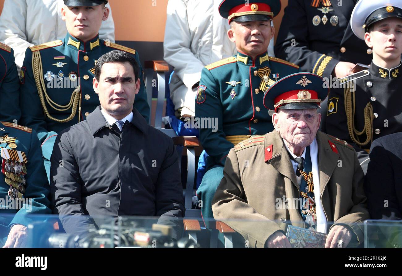 Moscow, Russia. 09th May, 2023. Turkmen President Serdar Berdimuhamedov, left, alongside veterans watches the annual Victory Day military parade through Red Square, marking the 78th anniversary of the victory over Nazi Germany in World War Two, May 9, 2023 in Moscow, Russia. Credit: Gavriil Grigorov/Kremlin Pool/Alamy Live News Stock Photo