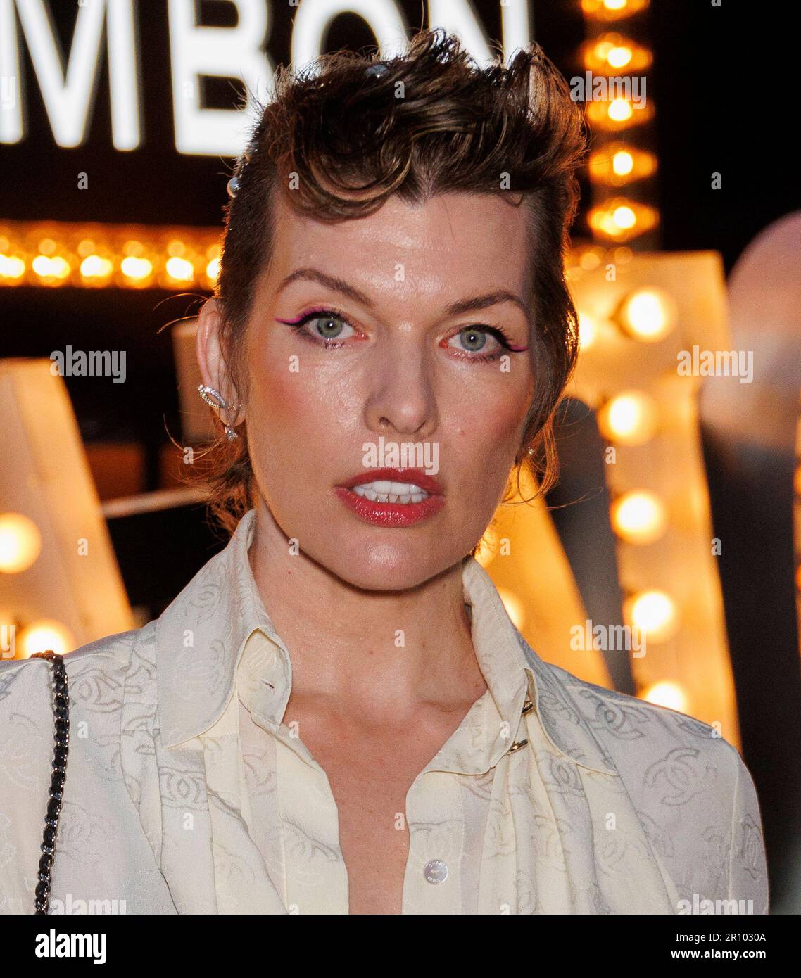 Milla Jovovich arrives at the Chanel Cruise 2022/2023 Fashion Show on
