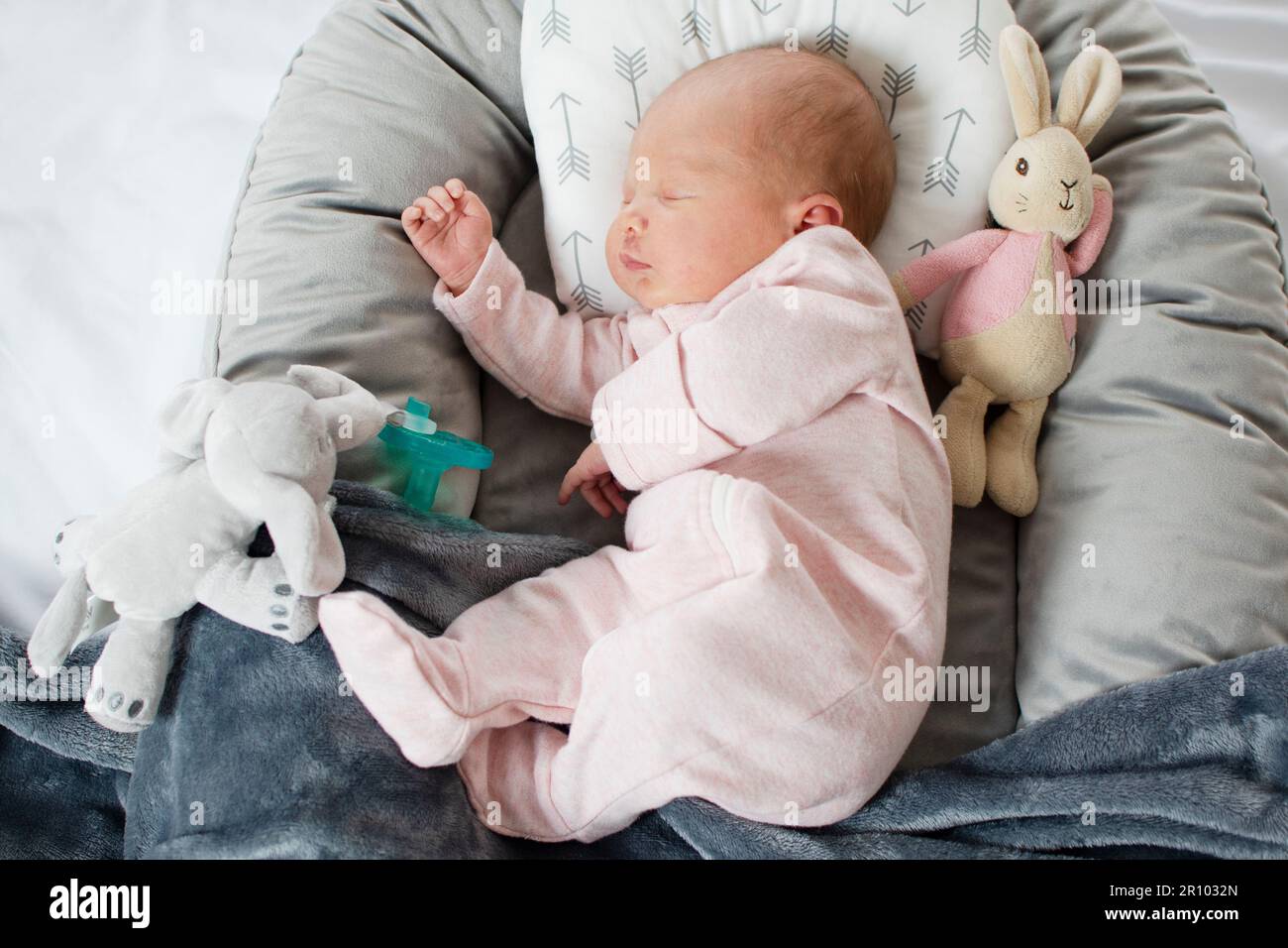 Caucasian Newborn baby sleeping in a baby lounger. Baby nest Stock Photo Alamy