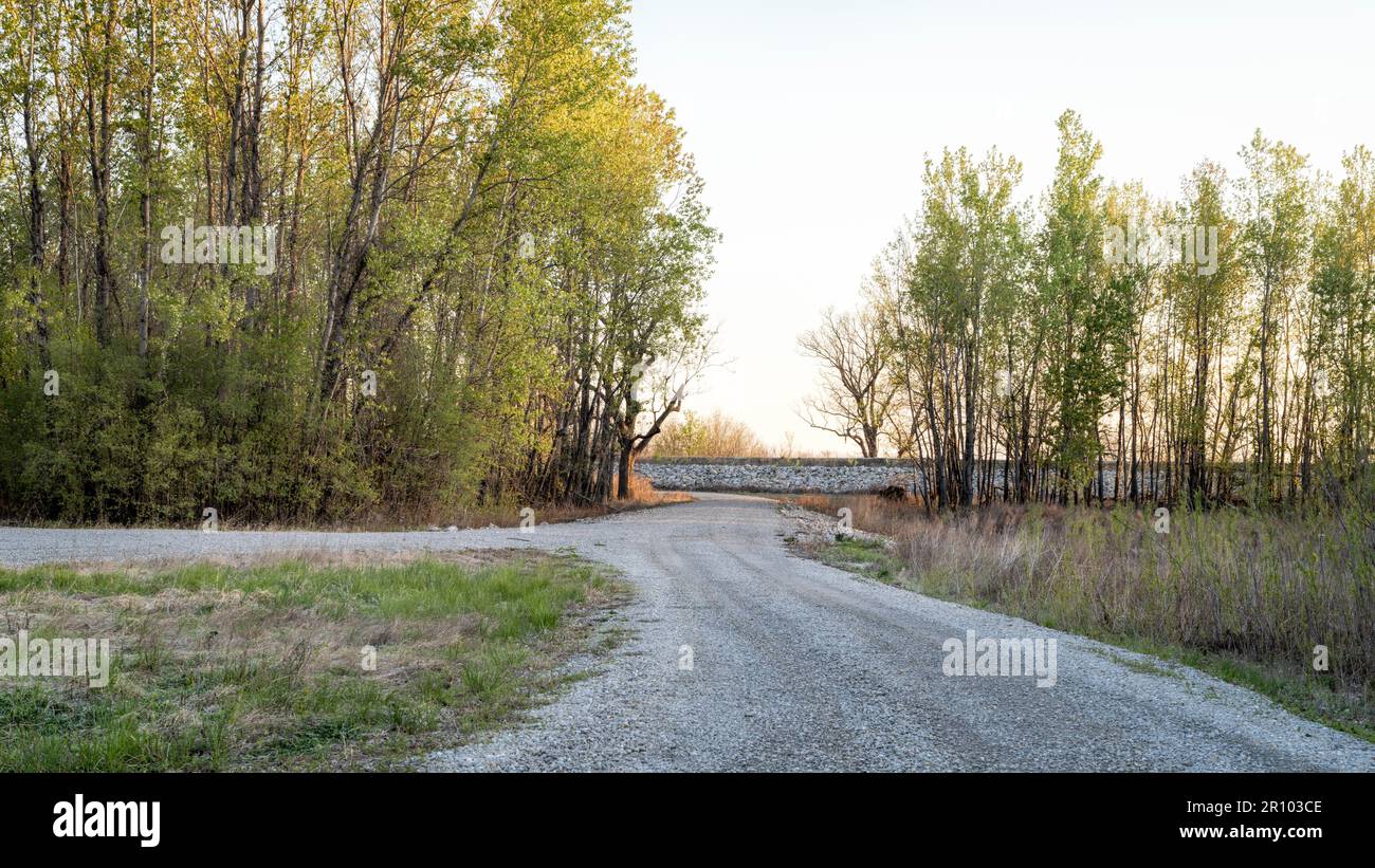 sunrise over riparian forest and levee in the valley of the Missouri ...