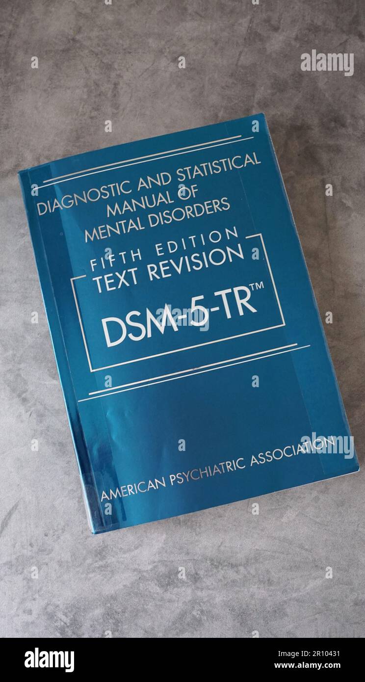 A copy of DSM-5-TR, the Diagnostic and Statistical Manual of Mental Disorders from the American Psychiatric Association. Stock Photo