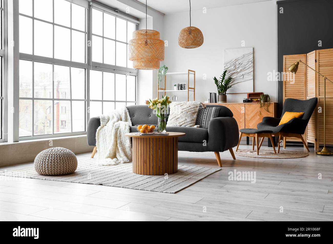 Interior of stylish living room with cozy sofa and coffee table near ...