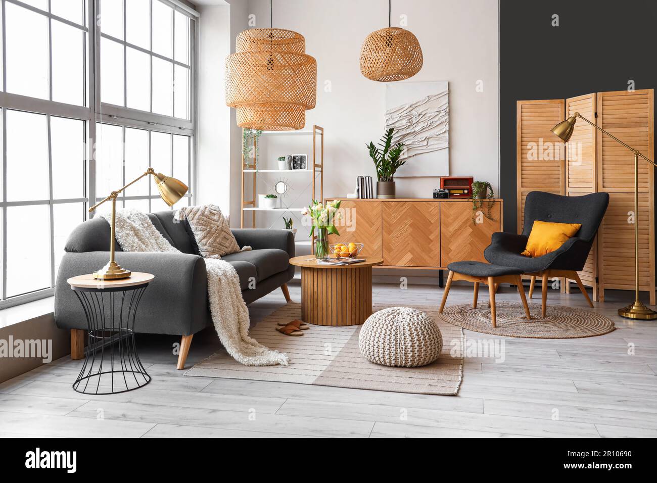 Interior of stylish living room with cozy sofa and coffee table near ...