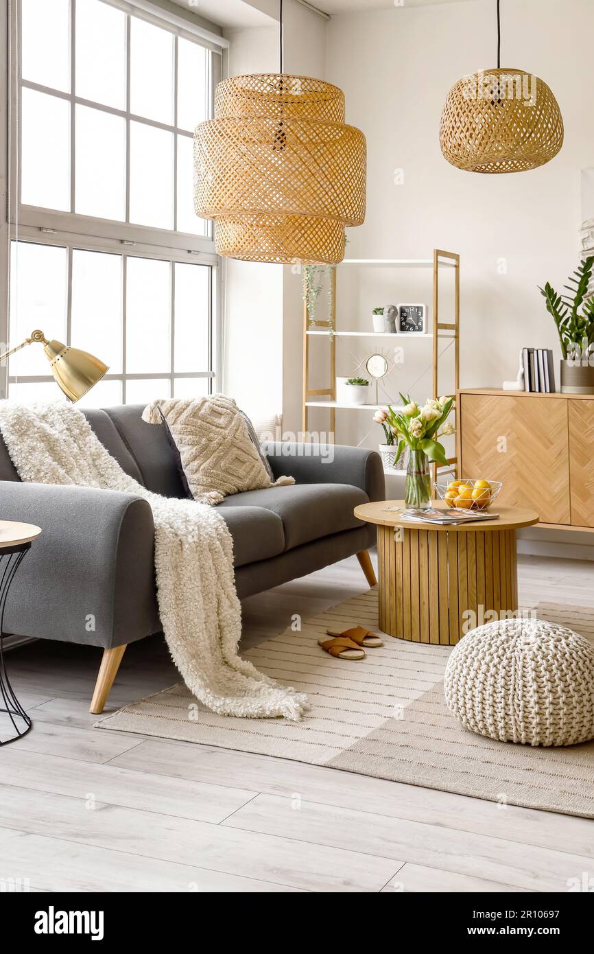Interior of stylish living room with cozy sofa and coffee table near ...