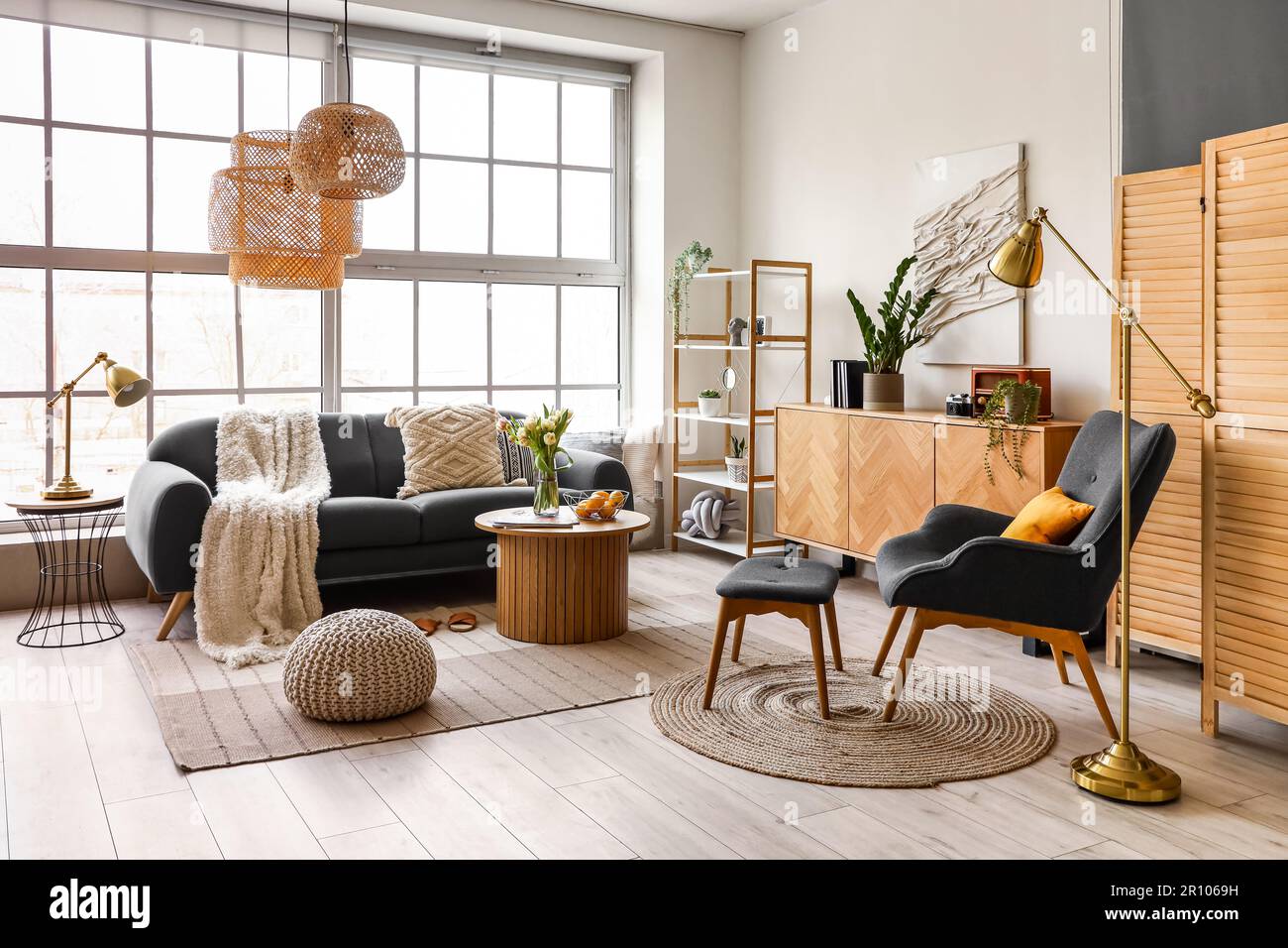 Interior of stylish living room with cozy sofa and coffee table near ...