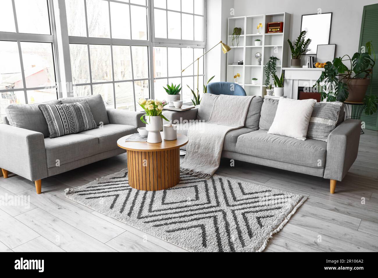 Interior of bright living room with cozy sofas and coffee table near ...