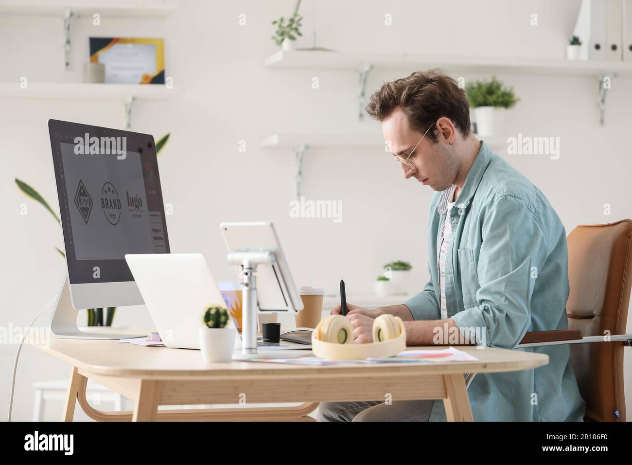 Male graphic designer developing logotype in office Stock Photo