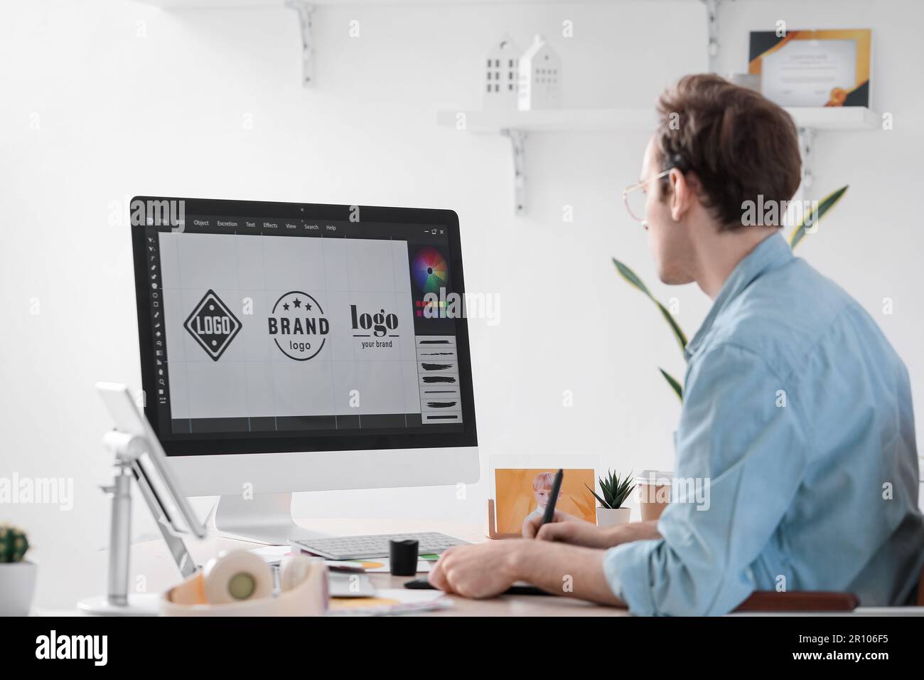 Male graphic designer developing logotype in office Stock Photo