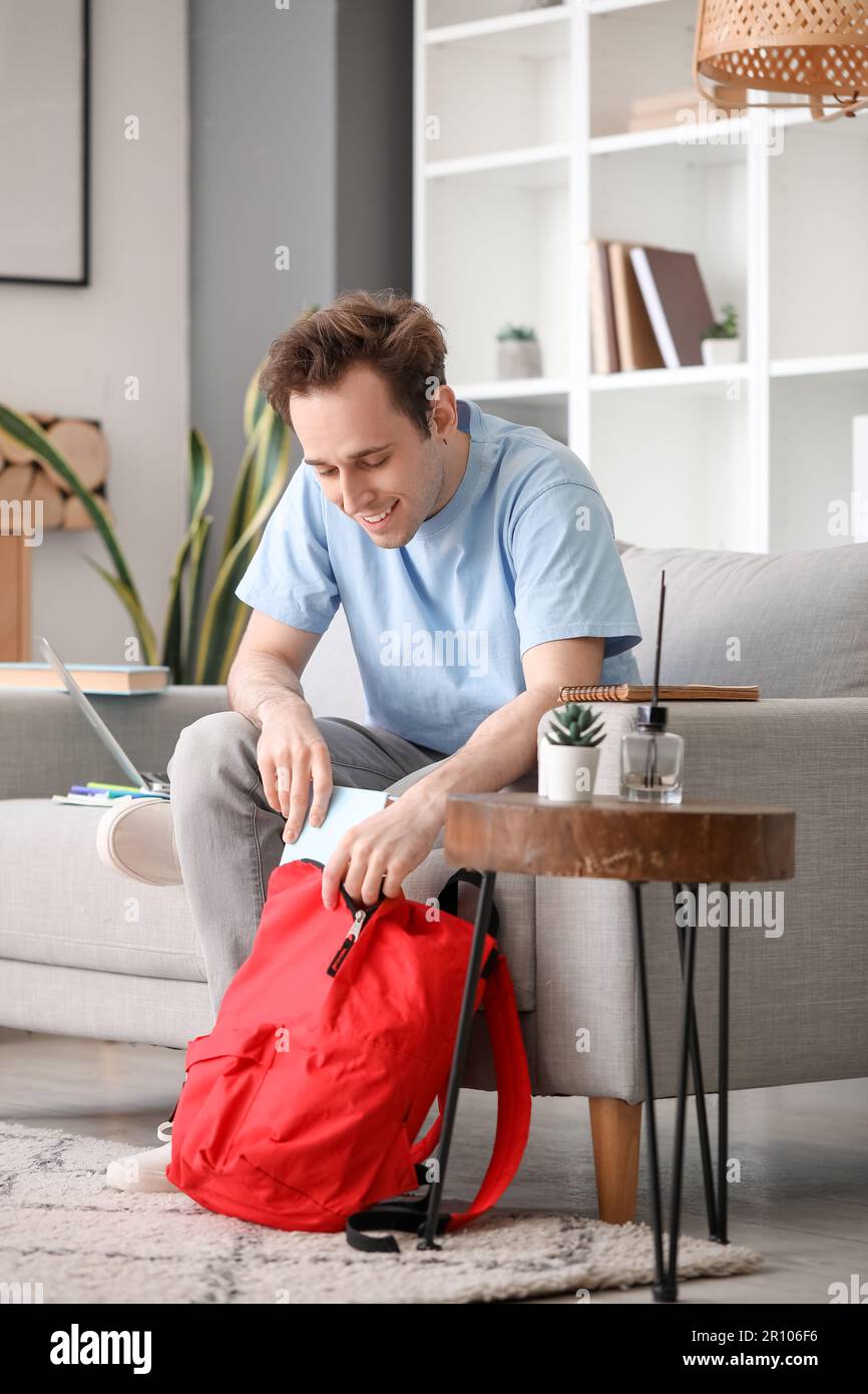 Male student with backpack at home Stock Photo