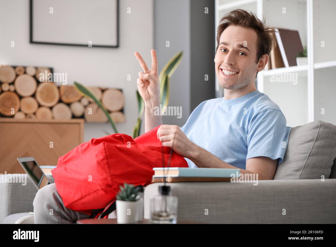 Male student with backpack at home Stock Photo