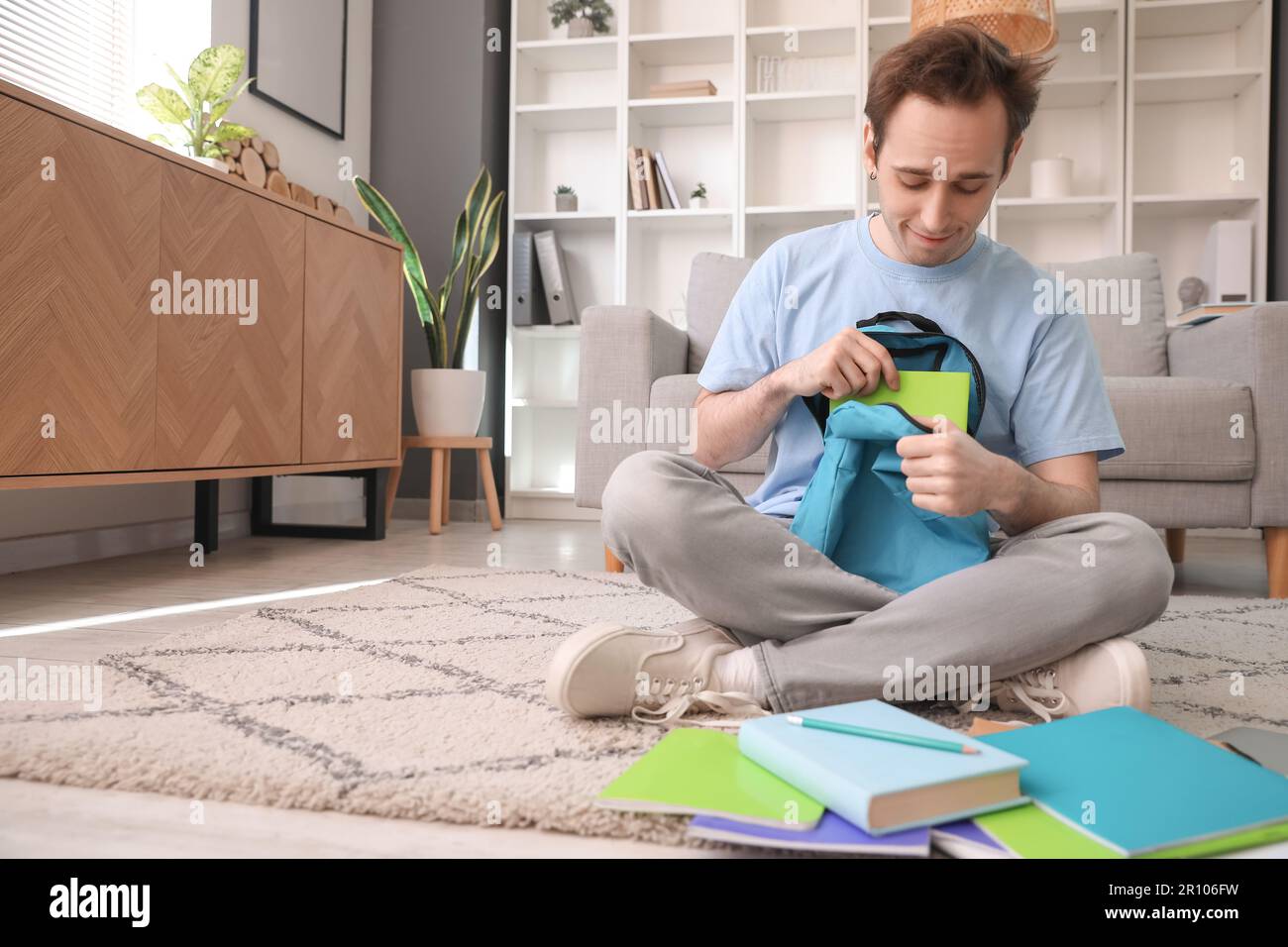 Male student with backpack at home Stock Photo
