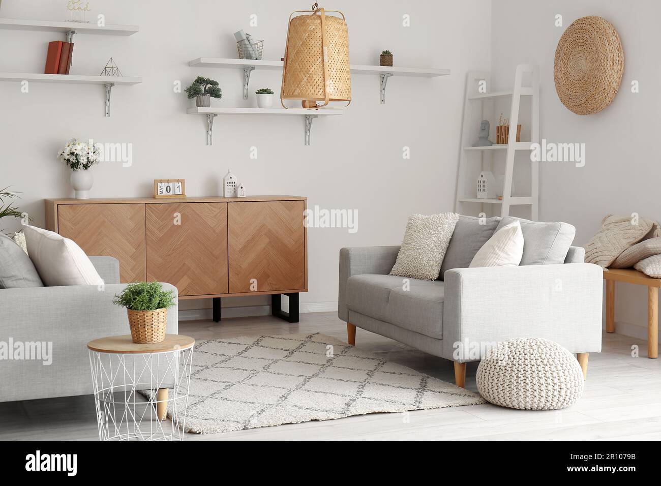 Interior of stylish living room with cozy sofas and wooden cabinet ...