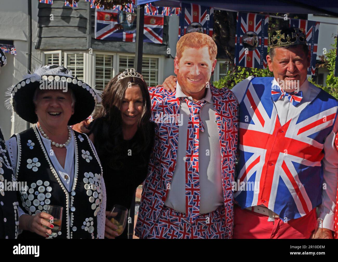 Portrait of Pearly Queen and People dressed as Prince Harry and Meghan at Street Party Celebrating King Charles III Coronation Surrey England Stock Photo