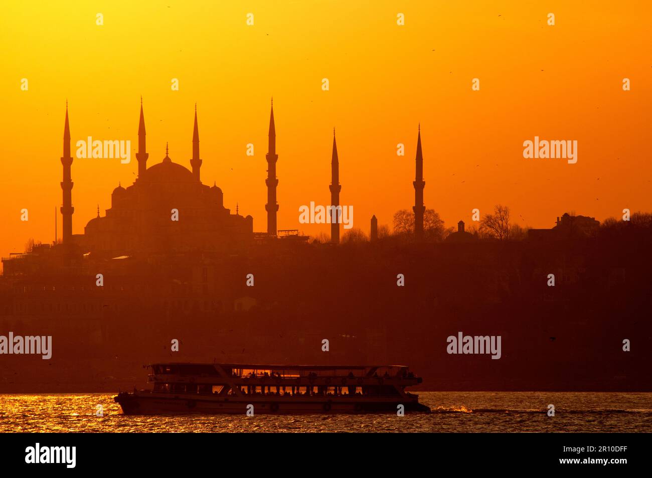 The view of the Blue Mosque and the boat at sunset is a sight worth seeing. Stock Photo