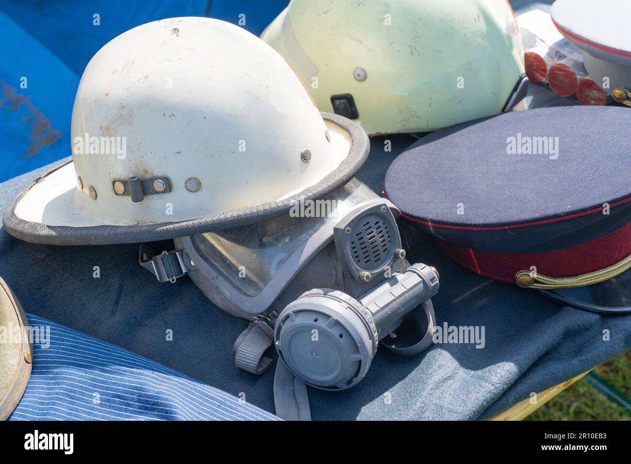 Old outdated firefighter helmet and mask Stock Photo