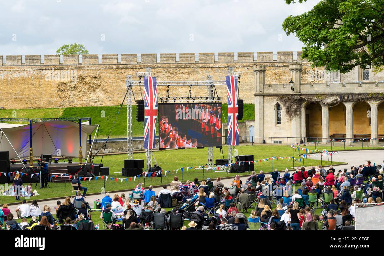 bass-baritone Sir Bryn Terfel singing at King Charles Coronation shown on large TV screen in front of large crowd in Lincoln Castle grounds, Lincoln C Stock Photo