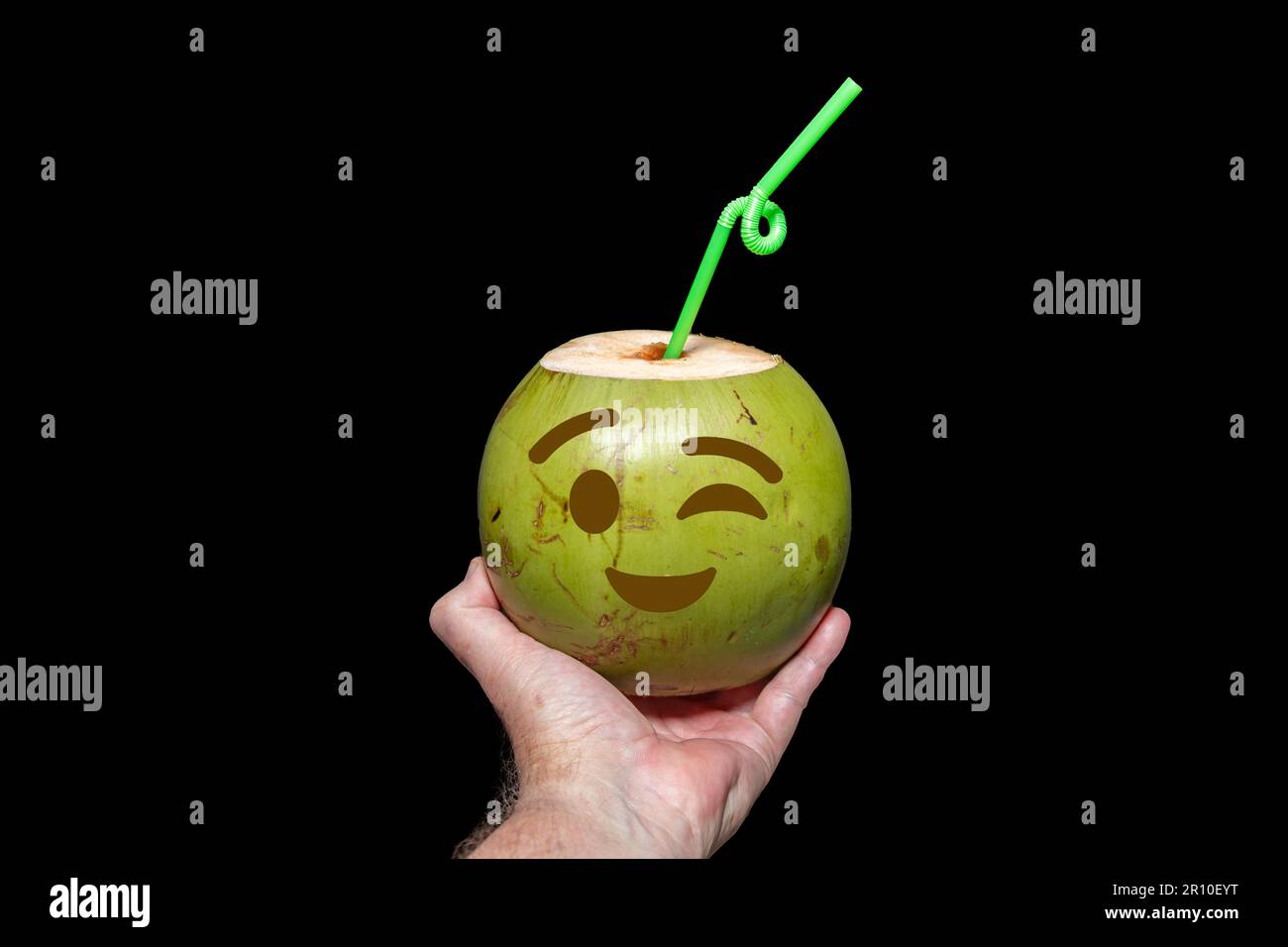 Green coconut with drawn emoji. tropical coconut water in selective