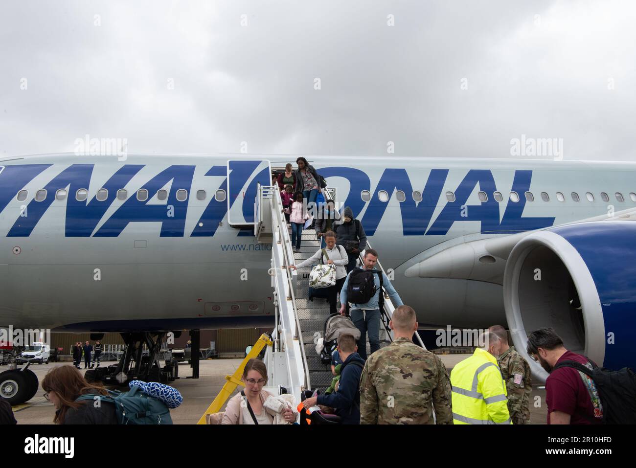 Personnel and their families disembark the Patriot Express aircraft after landing at Royal Air Force Mildenhall, England, May 9, 2023. The Patriot Express provides air transport for personnel permanently changing station to and from RAF Mildenhall, RAF Lakenheath, RAF Feltwell, RAF Alconbury and RAF Molesworth. (U.S. Air Force photo by Tech. Sgt. Anthony Hetlage) Stock Photo