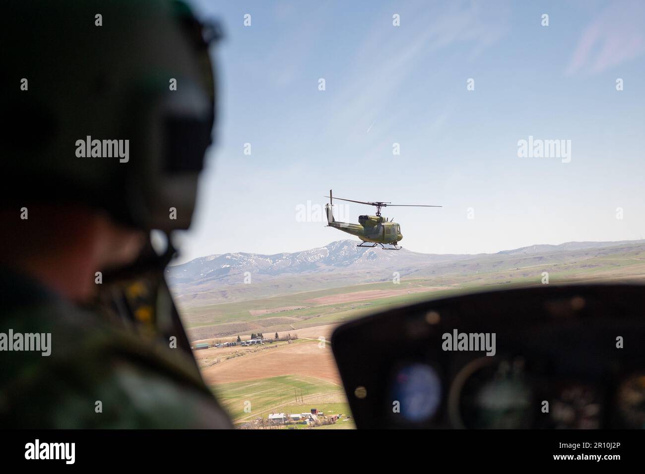 A 40th Helicopter Squadron UH-N1 Huey copilot keeps his eye on the Huey leading the way May 2, 2023, at Malmstrom Air Force Base, Mont. The 40th Helicopter Squadron, a tenant unit assigned to Malmstrom Air Force Base, Montana, began as Detachment 5 of the 37th Air Rescue and Recovery Squadron and was one of seven detachments in the 37th ARRS under Military Airlift Command.  The 37th ARRS was activated during the Korean War when helicopters were first used for medical evacuation. After the Vietnam War, 37th ARRS was deactivated, only to be reactivated in December 1973. (U.S. Air Force photo by Stock Photo