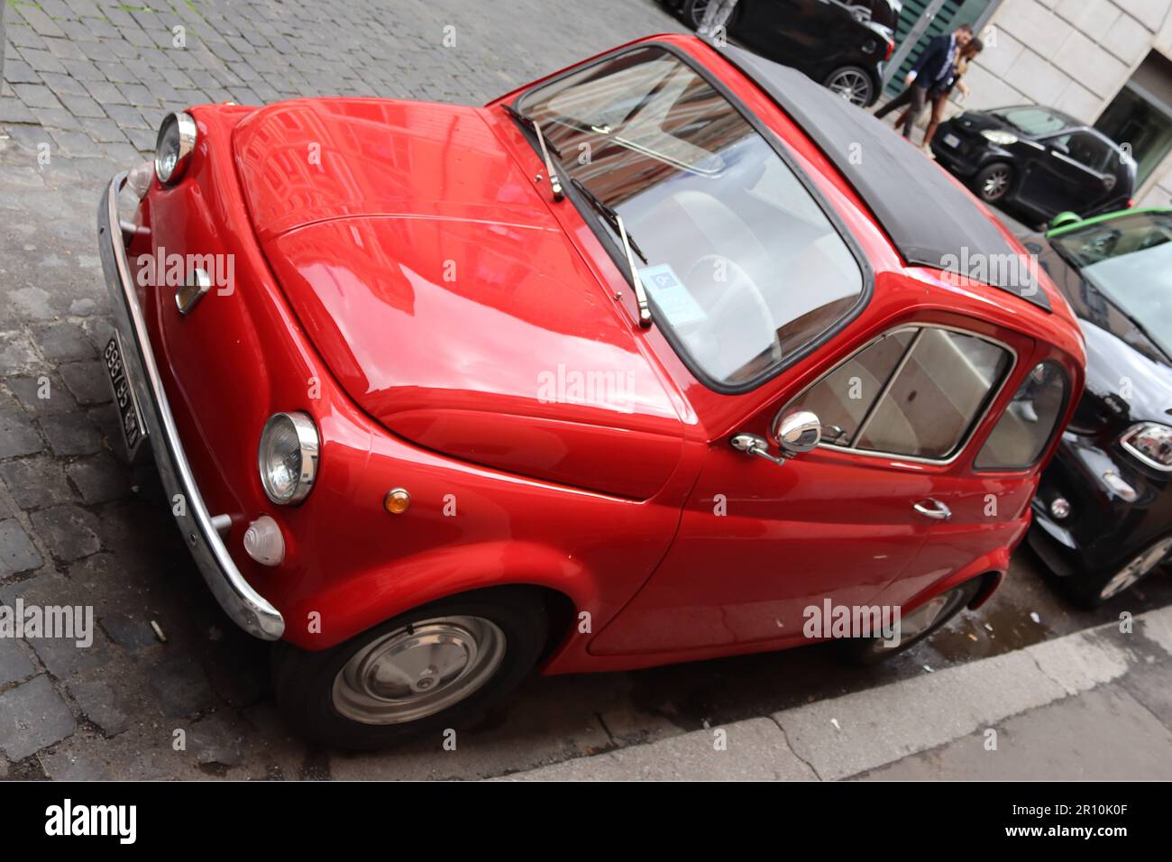 A restored 1965 Fiat Nuova 500 “Cinquecento” advertised for sale at €5000 in a Rome side street, April 2023. Stock Photo