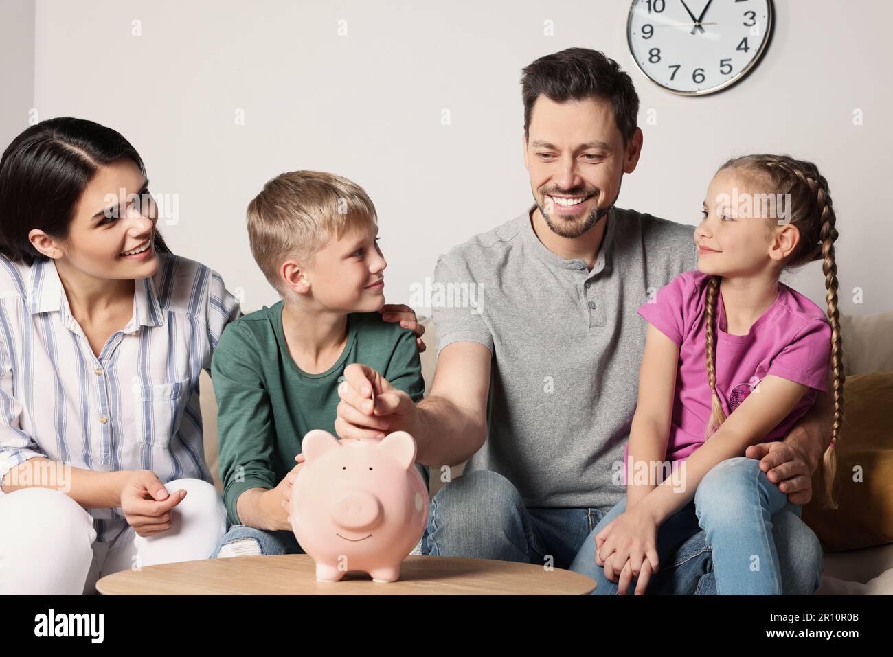 Father and son putting coin piggy bank hi-res stock photography and ...