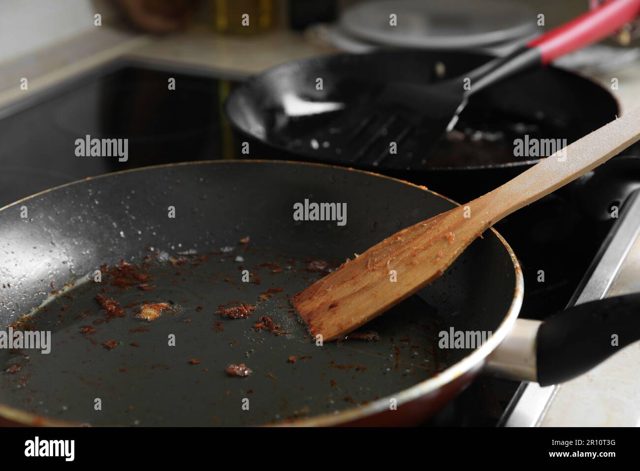 Frying pan with spatula and used cooking oil on stove, closeup Stock ...