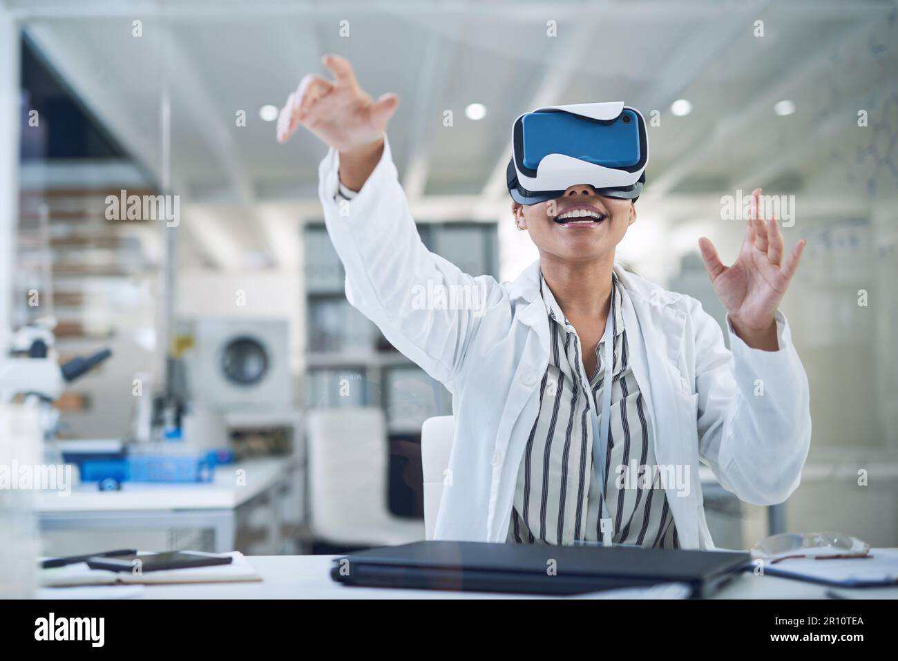 Extracting data from a new world. a young scientist using a virtual reality headset while working in a lab. Stock Photo