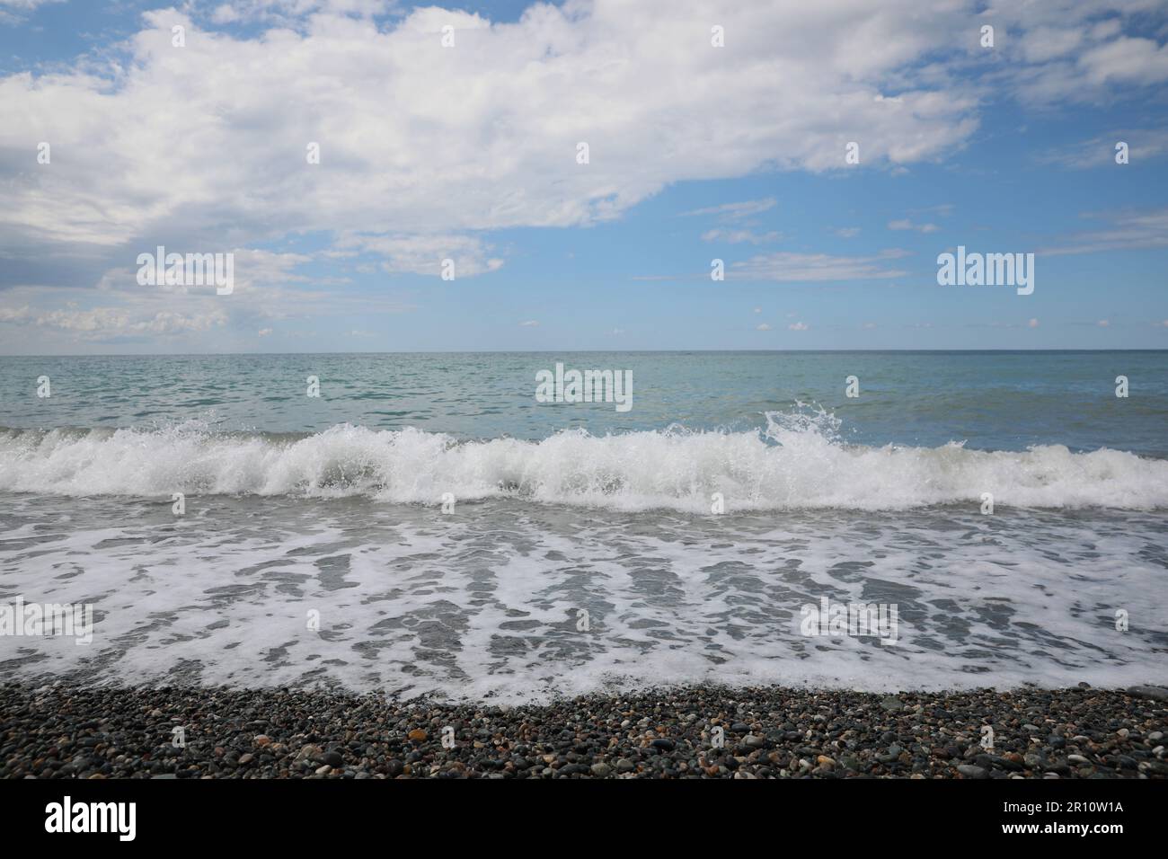 Picturesque view of beautiful sea shore under sky with fluffy clouds ...