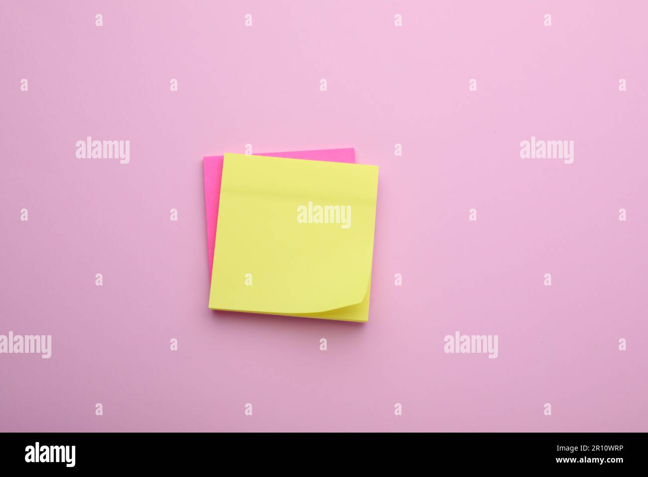Paper notes on pale pink background, top view Stock Photo