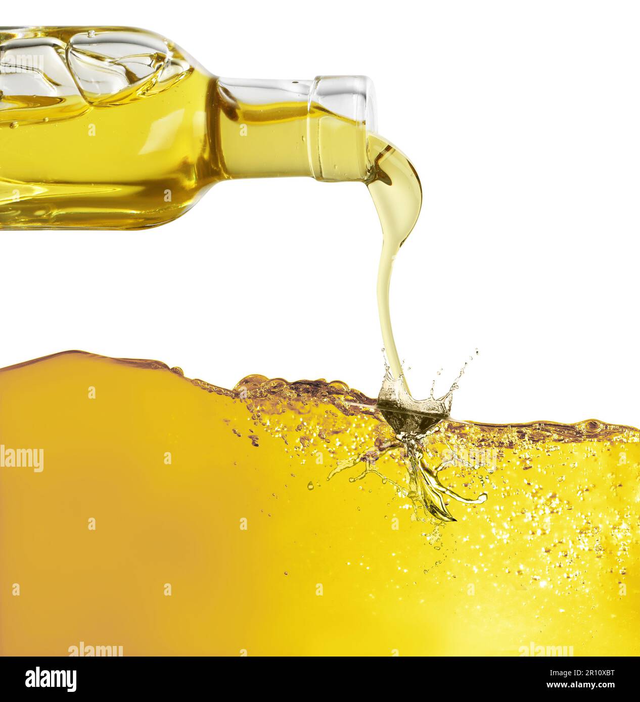 Pouring cooking oil from bottle against white background Stock Photo