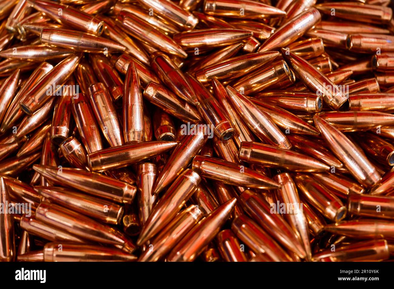 Copper metal bullets pile for weapons as background Stock Photo Alamy