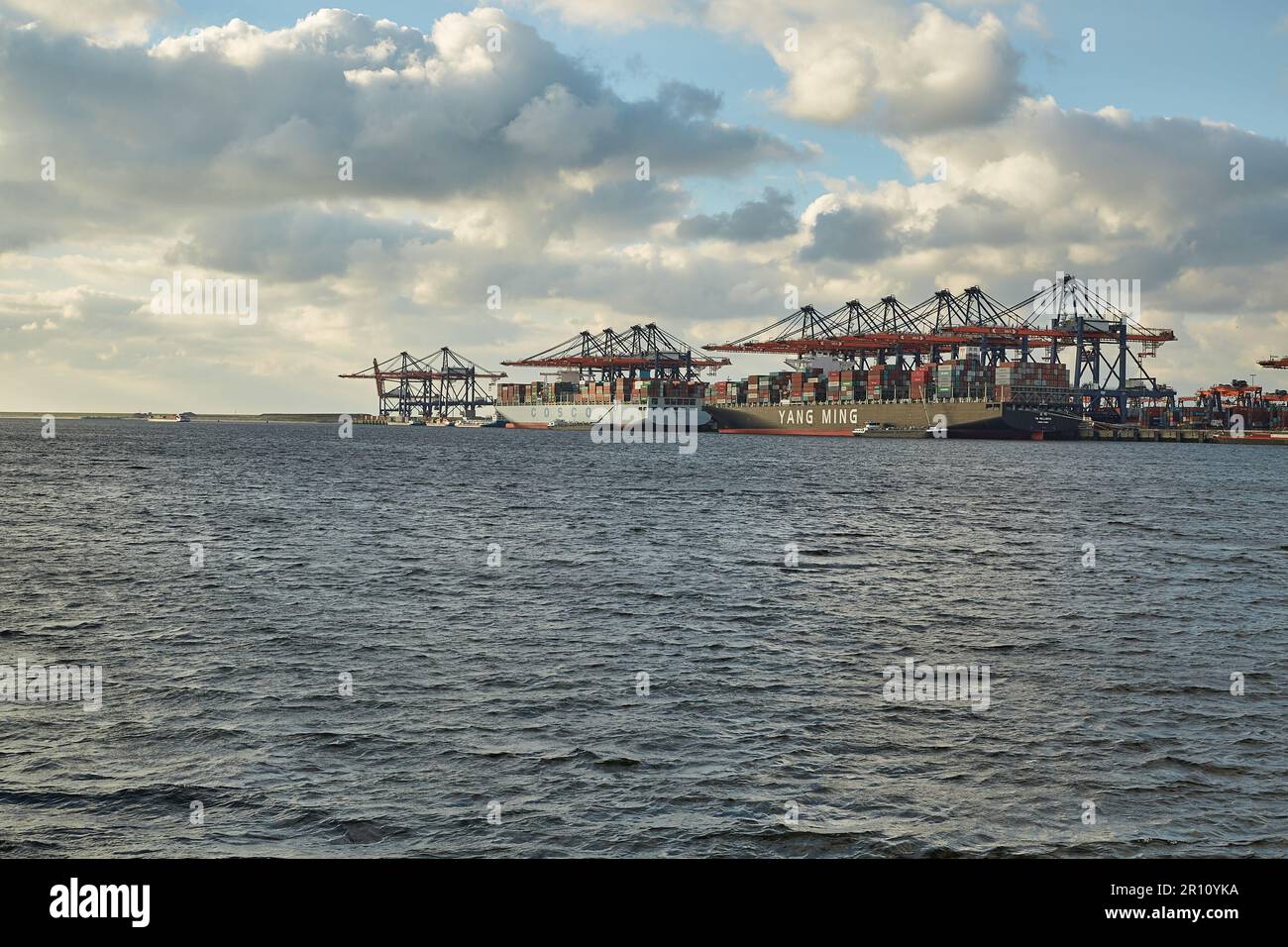 Loading containers on a ship Stock Photo - Alamy
