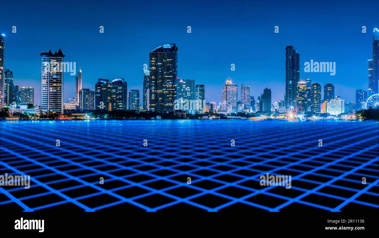 Cityscape of modern building at night with blue empty floor in front of ...