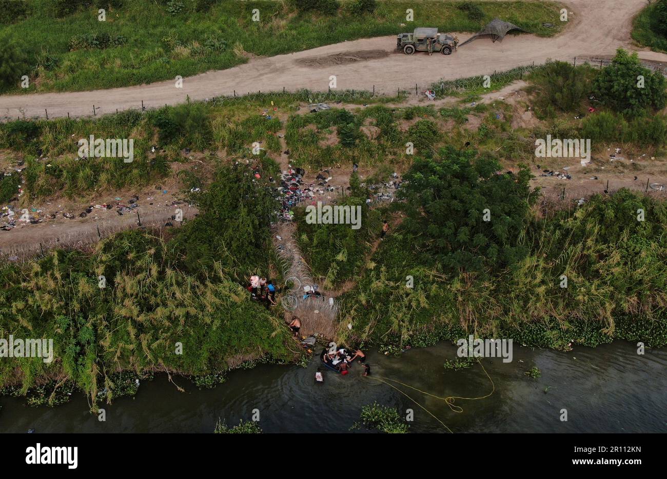 Migrants Cross The Rio Grande River Into The United States From