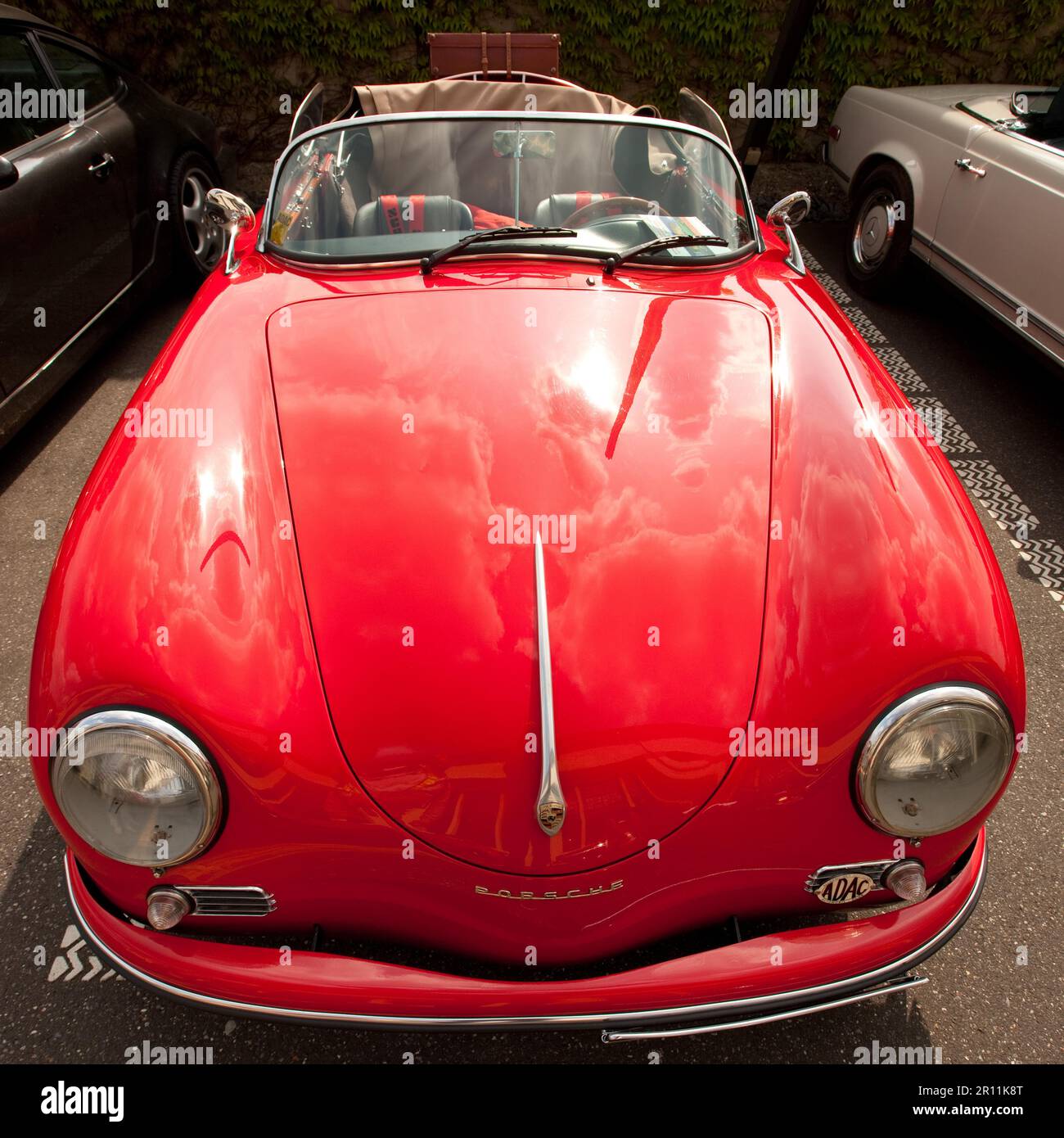 Vintage Porsche 356 Convertible, sports car, round headlights, driving open, red paint, shine, car care Stock Photo