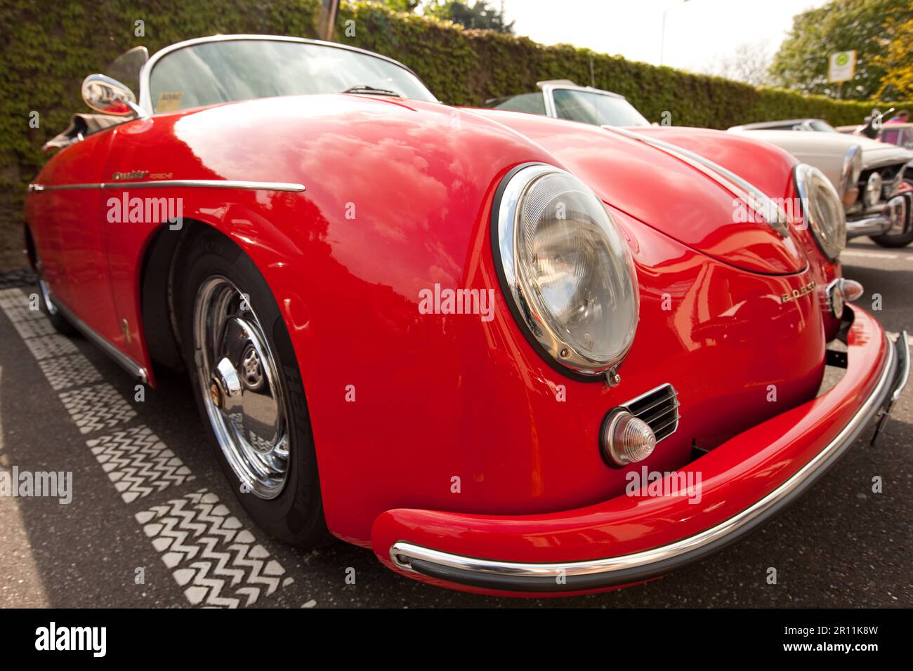 Vintage Porsche 356 Convertible, sports car, round headlights, driving open, red paint, shine, car care Stock Photo