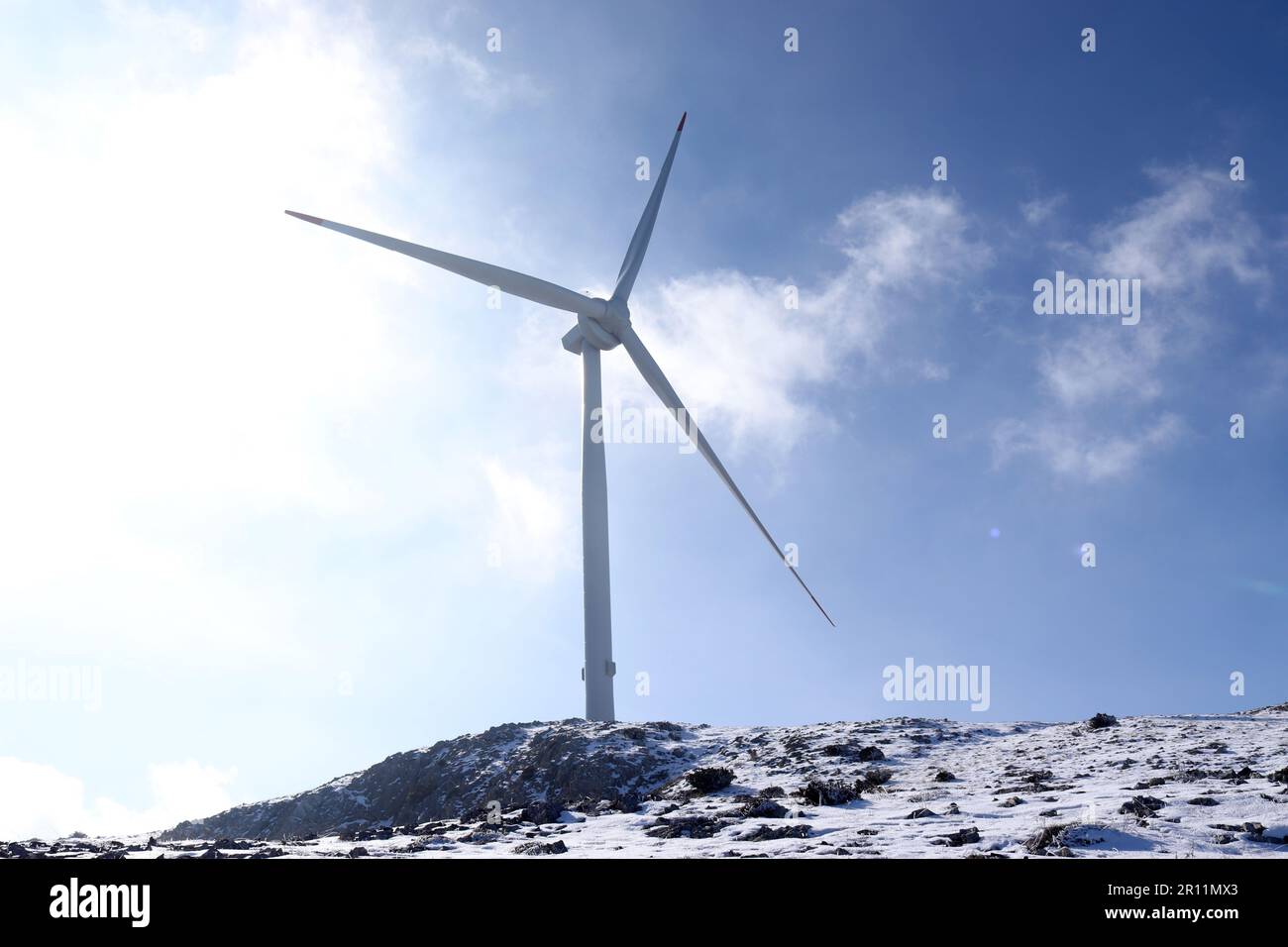 Wind turbine against blue sky Stock Photo - Alamy